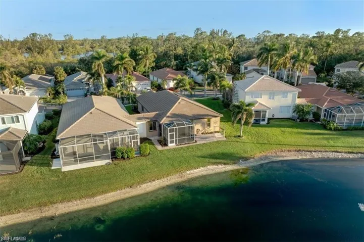 Aerial view of residential area featuring a large body of water