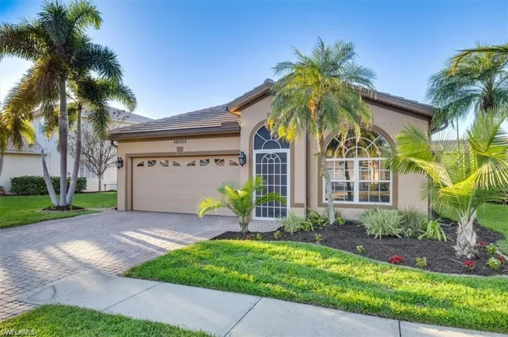 Ranch-style home with decorative driveway, a garage, and stucco siding