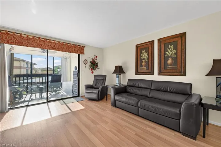 Living area featuring light wood-style flooring and a sunroom