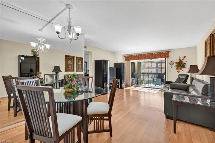 Dining area with light wood-style flooring and a chandelier