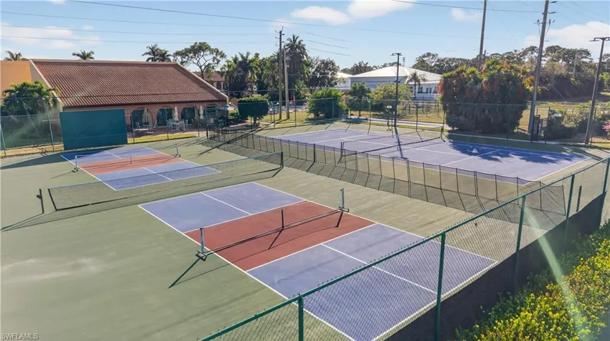 View of tennis court with community basketball court