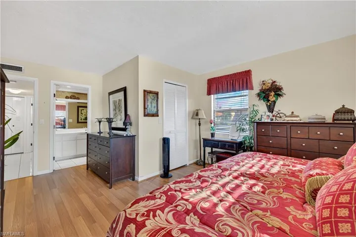 Bedroom with light wood-style flooring and a closet