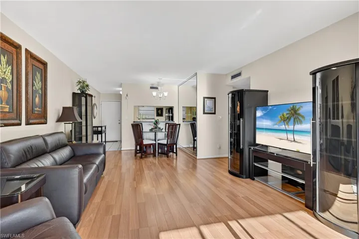 Living area featuring light wood-style flooring and a chandelier