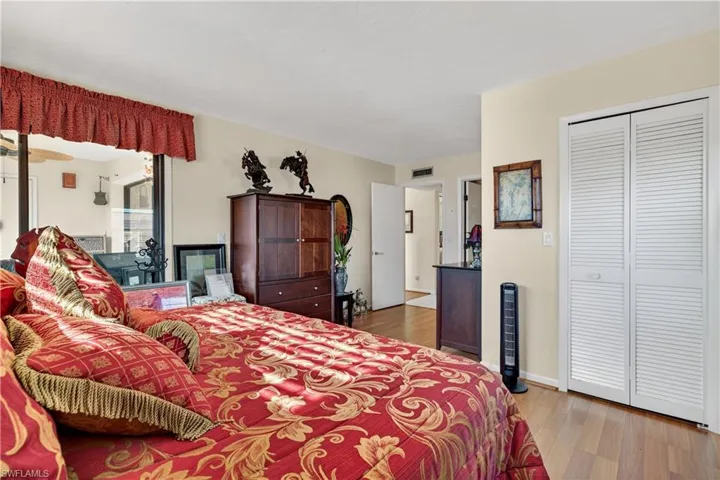Bedroom with light wood-type flooring and a closet