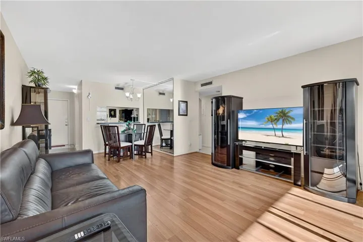 Living area featuring light wood finished floors and a chandelier