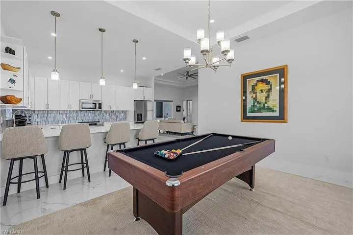 Dining area featuring a tray ceiling and a chandelier