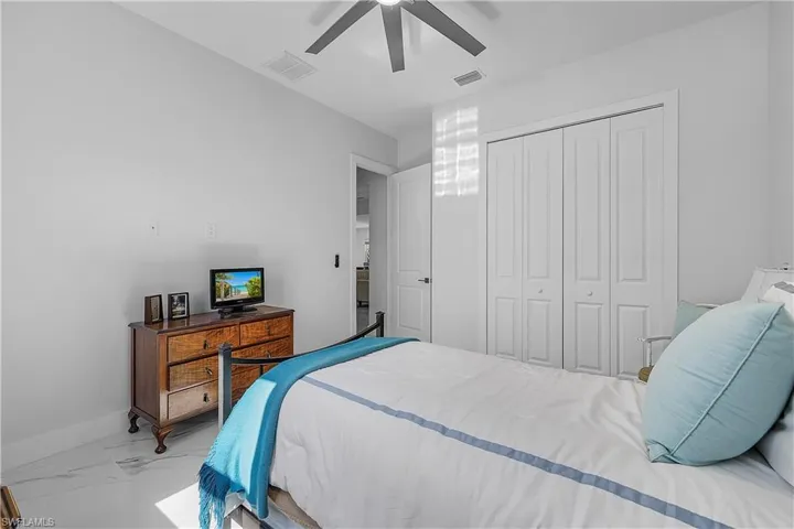 Bedroom featuring ceiling fan and a closet
