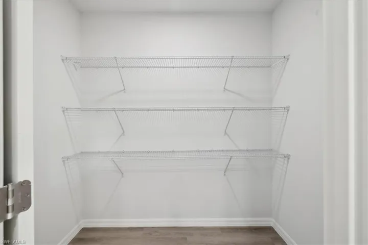 Walk in closet featuring hardwood / wood-style floors