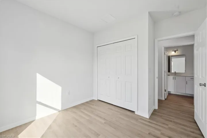 Unfurnished bedroom featuring a closet and light wood-type flooring