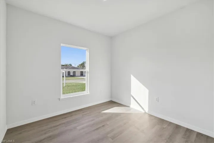 Unfurnished room with light hardwood / wood-style flooring