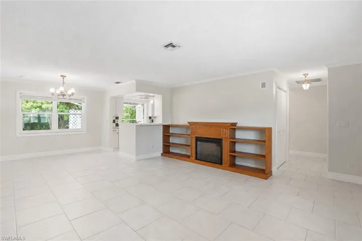 Spacious living area featuring light-toned tile flooring throughout