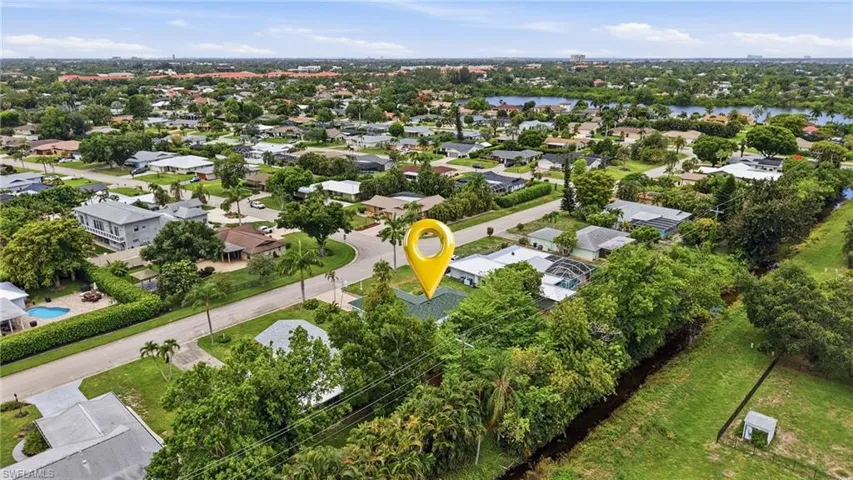 Established neighborhood featuring mature landscaping, a network of residential streets, and distant water features