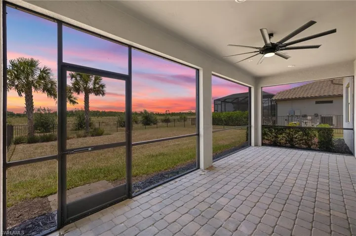 Unfurnished sunroom featuring ceiling fan