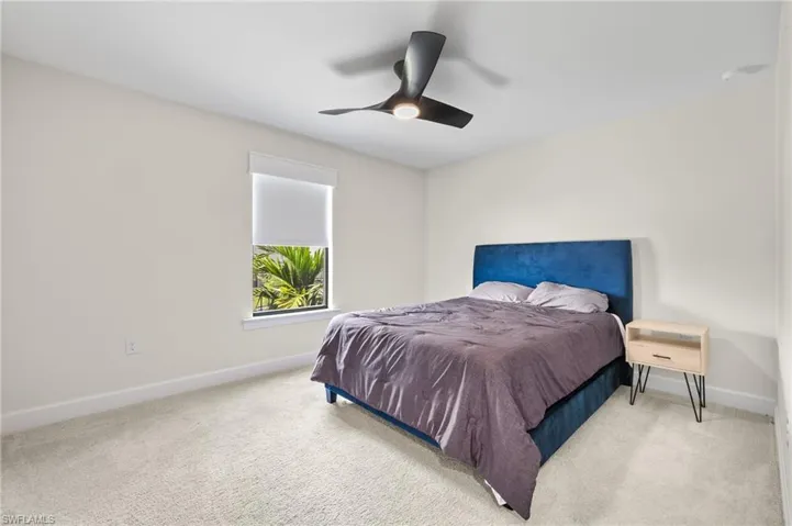 Bedroom featuring ceiling fan and carpet floors