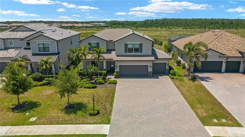 View of front of property featuring a front lawn and a garage