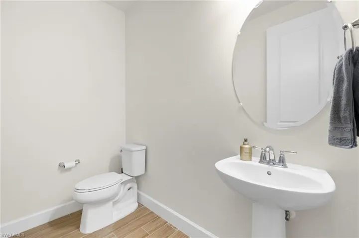 Bathroom featuring wood-type flooring and toilet