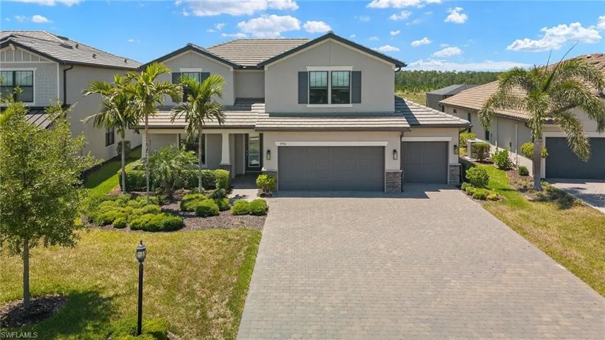 View of front of house featuring a garage and a front yard