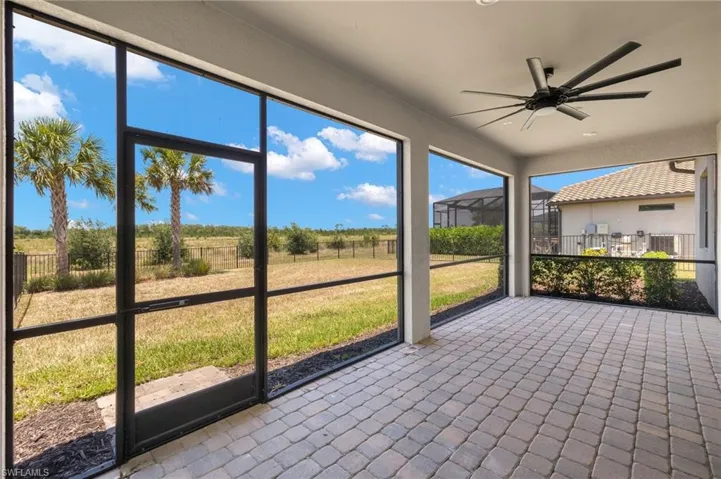 Unfurnished sunroom featuring ceiling fan
