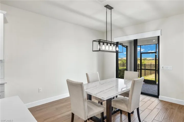 Dining room featuring a chandelier and light wood-type flooring
