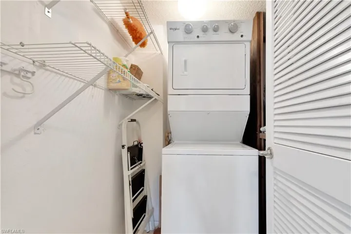Laundry area featuring stacked washer / drying machine