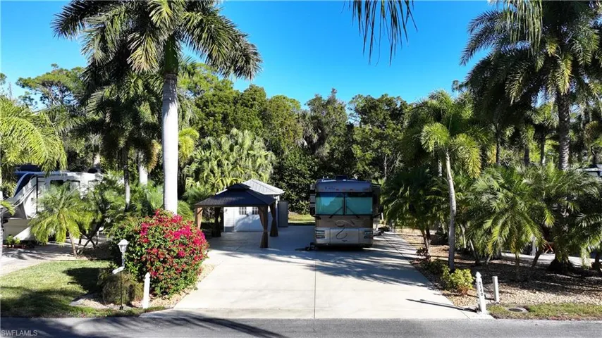 View of home's community with a gazebo and concrete driveway