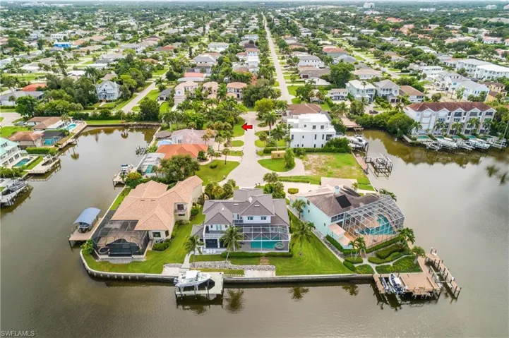 Birds eye view of property with a water view