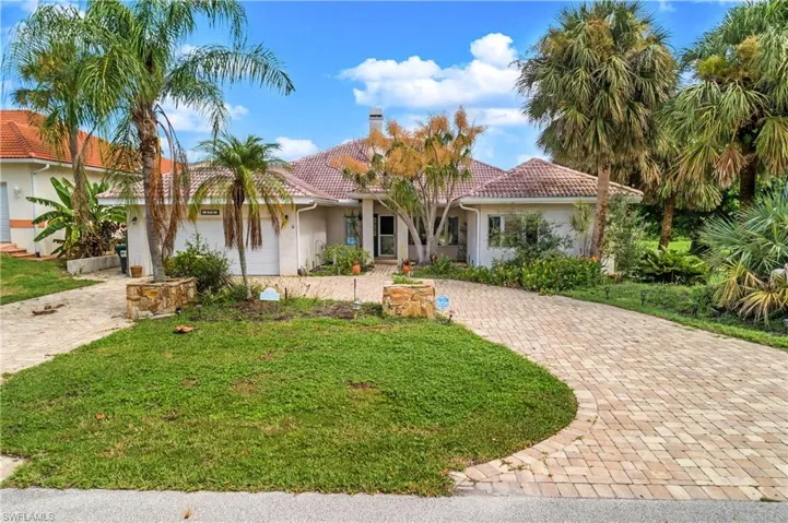 Mediterranean / spanish home with a front yard