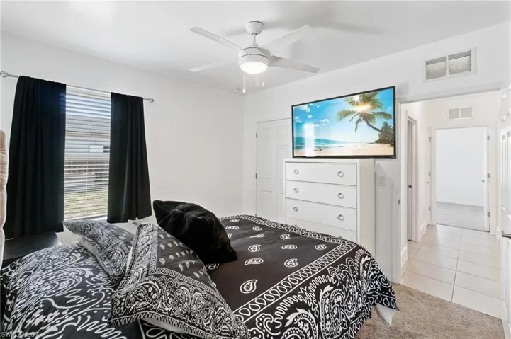 Secondary bedroom featuring ceiling, neutral carpet & lots of natural light.