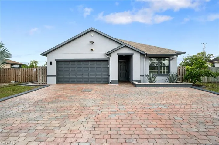 Ranch-style home with extended custom paver driveway
