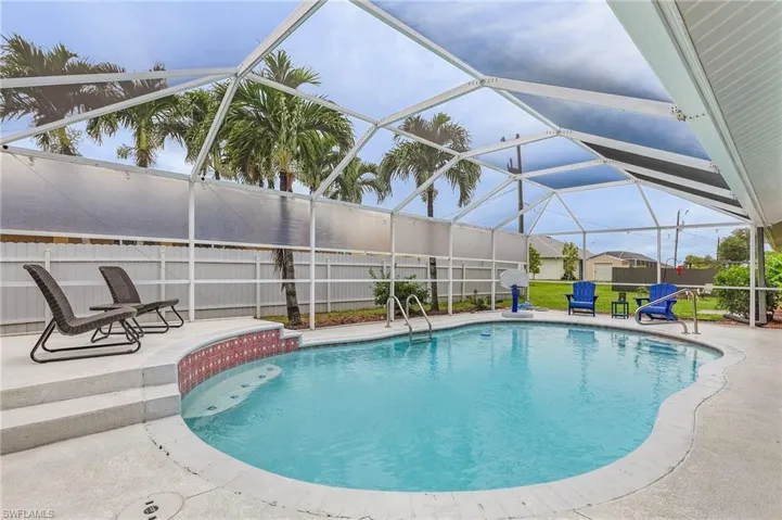 View of swimming pool with a lanai and a patio area
