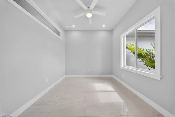 Room featuring a white ceiling fan with integrated lighting, recessed ceiling lights, and tile flooring