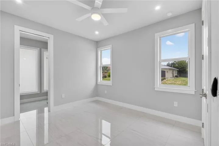 Bright interior space featuring white tile flooring and light gray walls