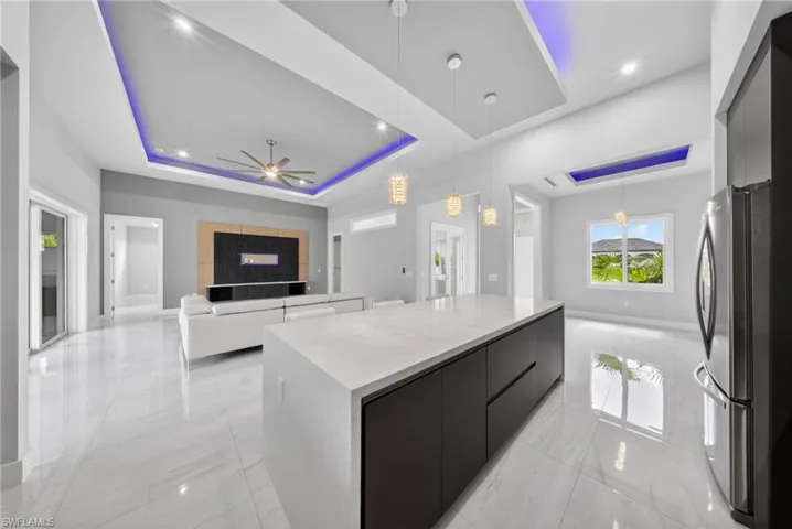 Expansive open-concept interior featuring light-toned large format tile flooring throughout