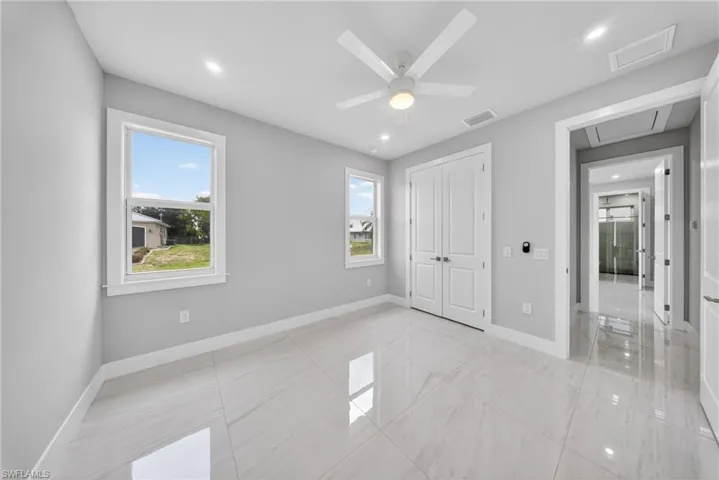 Bright interior featuring large windows, white trim, and light gray walls