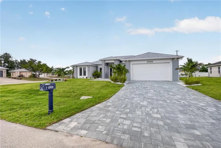 Contemporary single-story residence with a light gray exterior