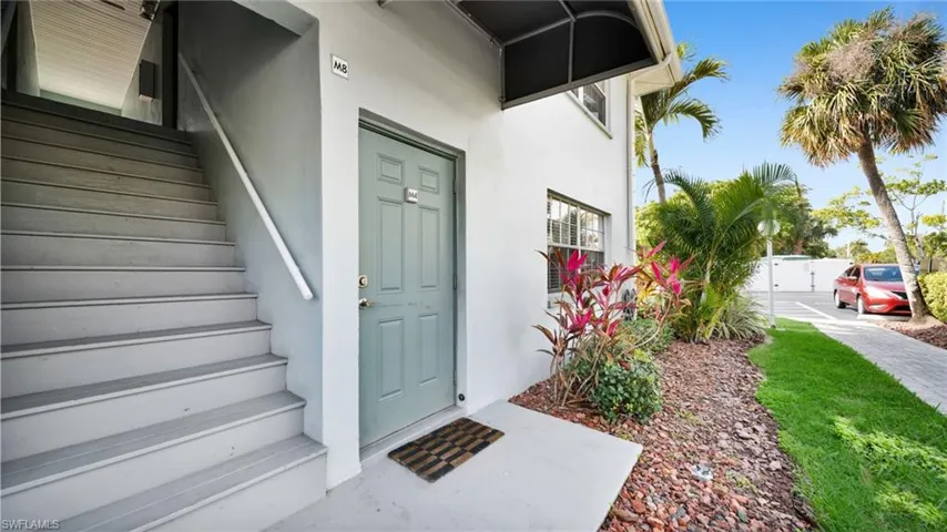 Entrance to property featuring stucco siding