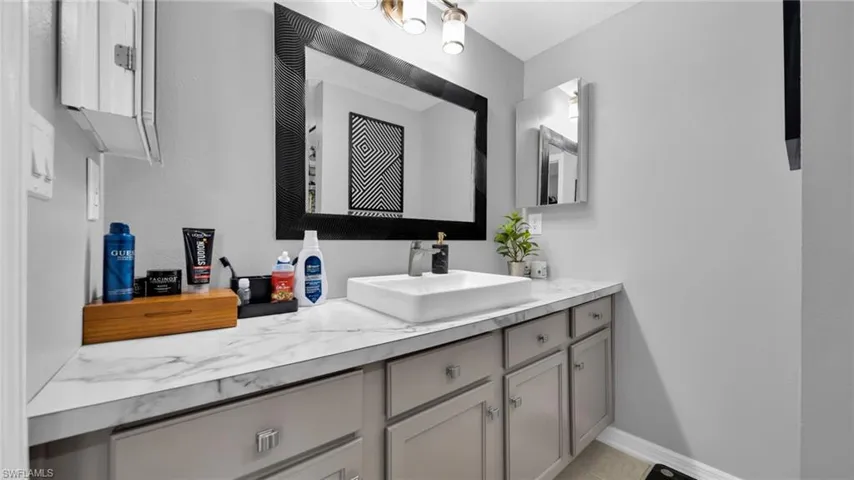 Bathroom with vanity and baseboards