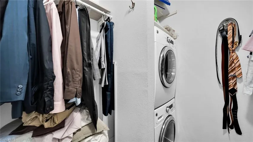 Laundry area with stacked washer and clothes dryer