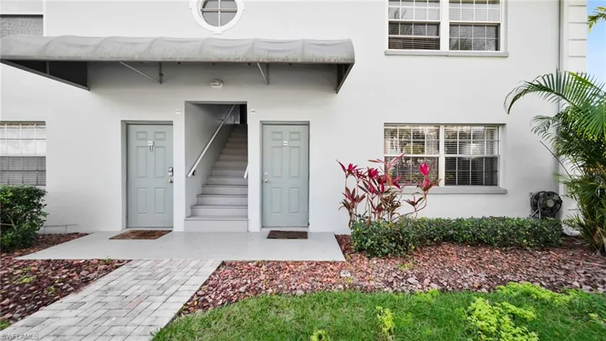 Doorway to property with stucco siding