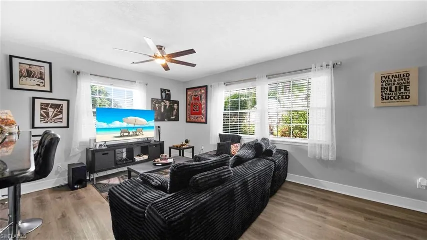 Living room featuring wood finished floors and ceiling fan