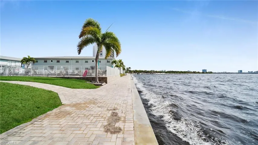 Dock featuring a fenced front yard and a water view