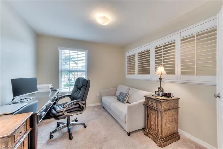 Home office featuring light colored carpet
