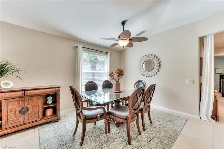 Tiled dining space featuring ceiling fan