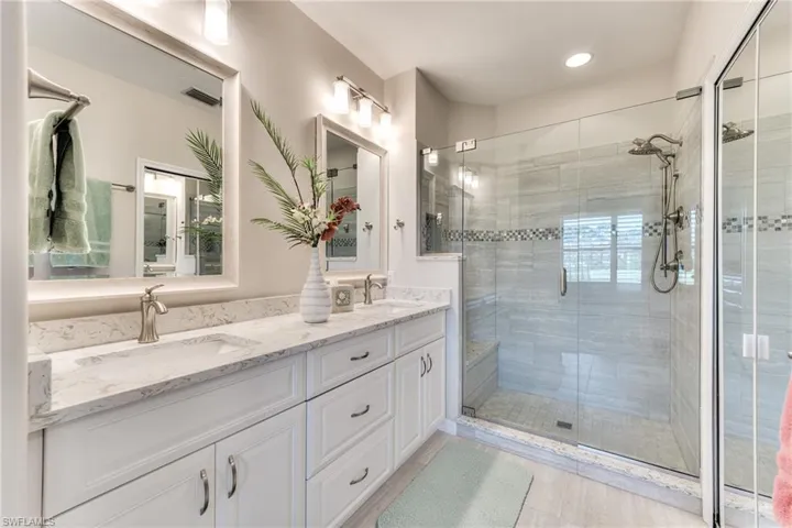 Bathroom featuring walk in shower and vanity