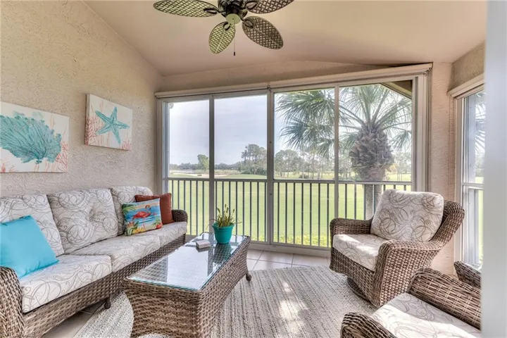 Sunroom featuring ceiling fan and vaulted ceiling
