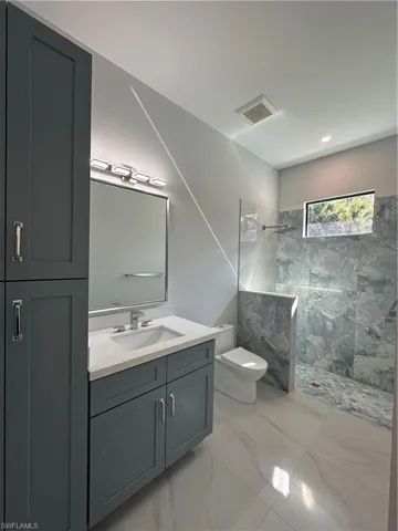 Full bath featuring a walk in shower, vanity, and recessed lighting. Next to the pool area.