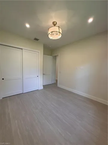 Unfurnished bedroom featuring a closet, recessed lighting, and light wood finished floors