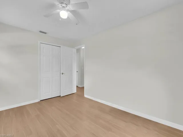 Unfurnished bedroom featuring baseboards, light wood-type flooring, a closet, and a ceiling fan
