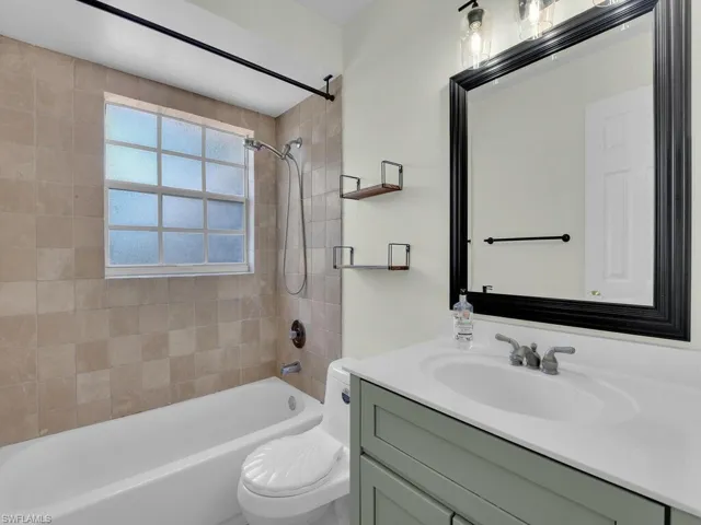 Full bath with toilet, bathtub / shower combination, and vanity
