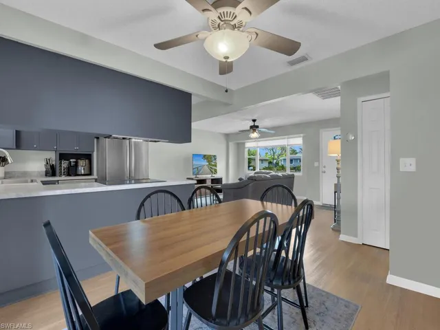 Dining room with ceiling fan, light wood-type flooring, and baseboards